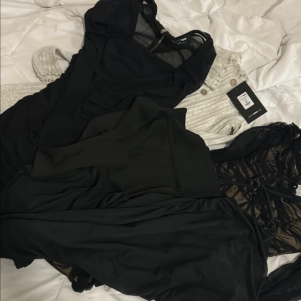 4 black mini dresses and 1 tan mini dress. A pile of going out dresses